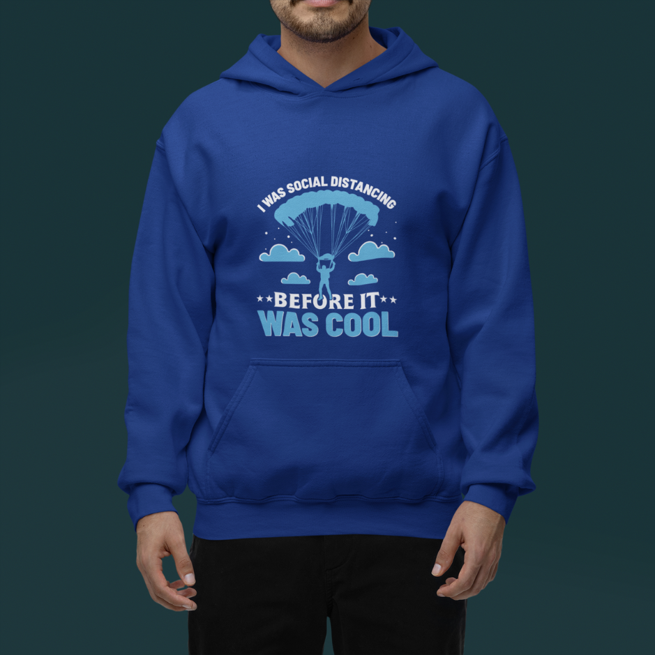 Man wearing  royal  blue 'I was social distancing before it was cool' hoodie, featuring a parachute design