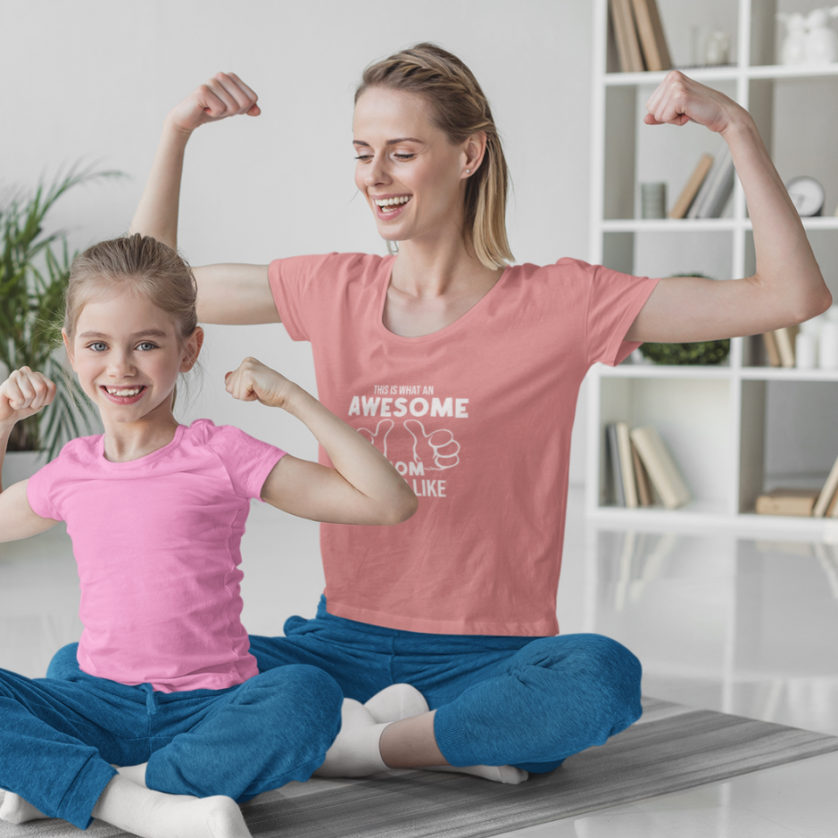 An awesome mom and her adorable dautgher sitting on the house floor, showcasing their matching orchid pink and pink  t-shirts with pride