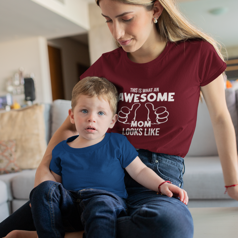 An awesome mom and her adorable son sitting on the house floor, showcasing their matching cardinal and blue t-shirts with pride