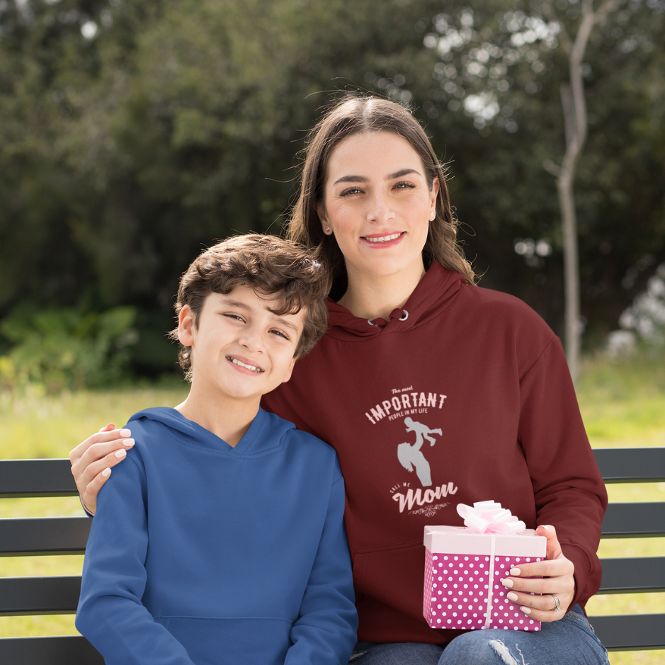 A mother, clad in a marron hoodie with the inscription 'The most important people in my life, they call me mom,' sitting with  her son on a serene journey, epitomizing the essence of maternal love and devotion