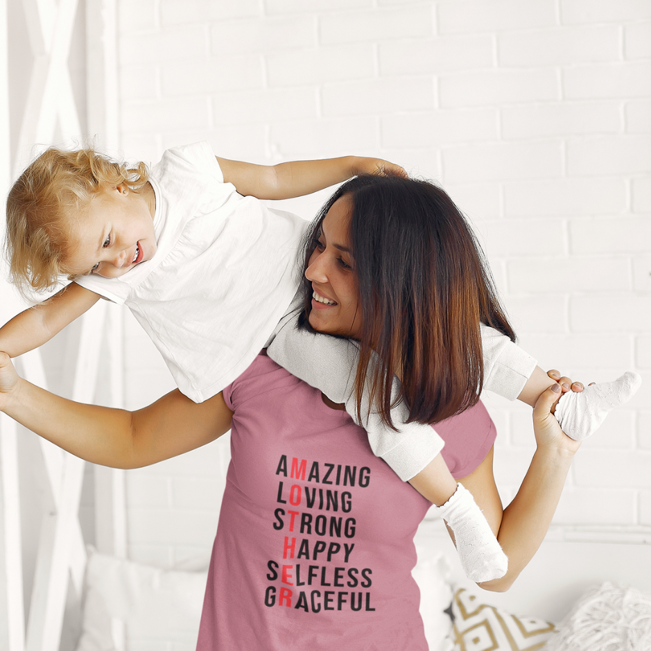 mom wearing a Heather mauve  tee themed as loving, strong, happy, selfless, and graceful mother playing with her dautgher